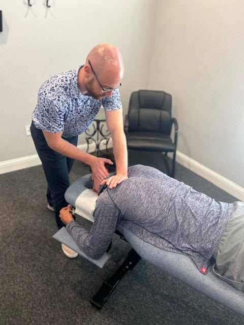 Who We Help 2 Chiropractic adjustment being performed on a patient at Antignolo Chiropractic office.