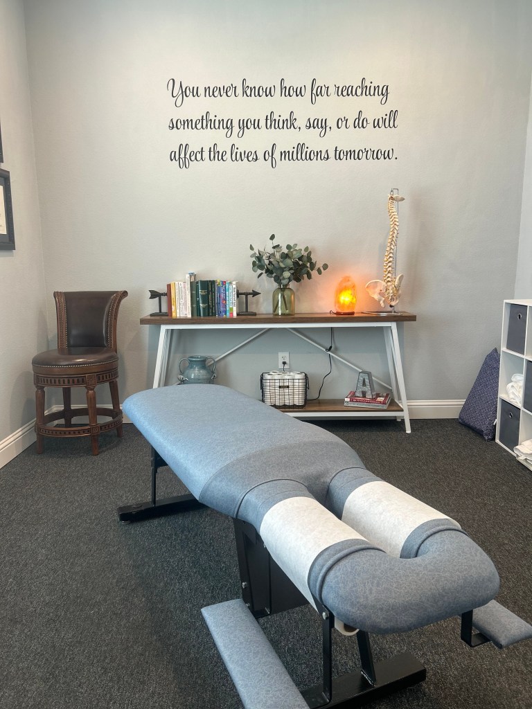About 1 Comfortable chiropractic adjustment table in a soothing clinic room for optimal patient care.