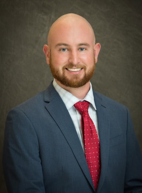 About 5 Wellness-focused male chiropractor in professional attire at Antignolo Chiropractic clinic.